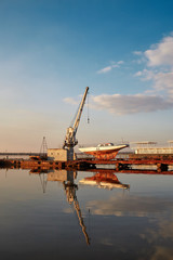 Fototapeta premium cranes in the evening port. sunny yacht club