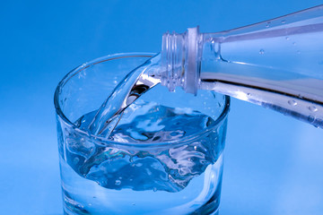 Fresh drinking water. Clean drinking water Poured from a bottle into a clear glass