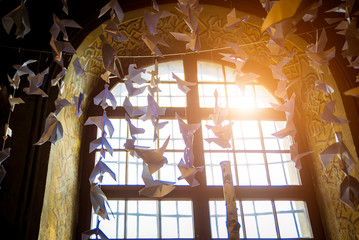 Origami white paper doves hanging on a rope