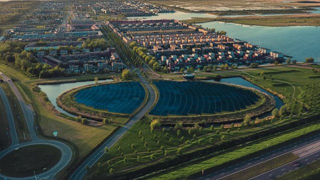 Aerial hyperlapse of modern sustainable residential neighbourhood in Almere, The Netherlands, with solar panels island providing city heating