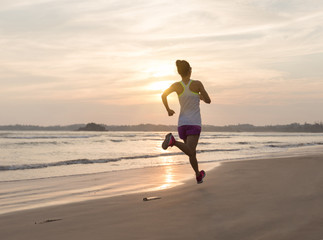 Fototapeta na wymiar young fitness woman running at beach