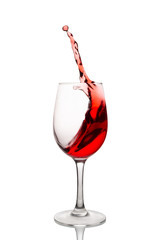 Red wine splash in a glass isolated on white background. 
