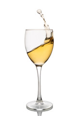 White wine is poured into a wine glass on a white background.