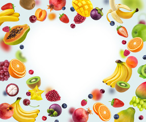 Heart shape frame made of different fruits and berries, isolated on white background, healthy food concept