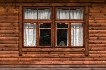 Fototapeta na wymiar Log cabin wall with window