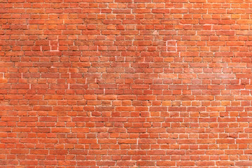 Texture of a red brick wall as a background or wallpaper