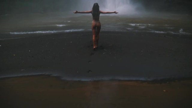 Beautiful girl having fun at the waterfalls in Bali. Concept about wanderlust traveling and wilderness culture