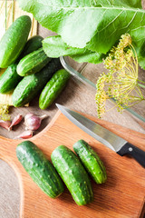Fresh cucumbers on wooden board prepared for pickling