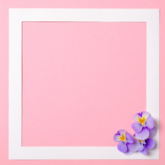 Flat lay frame with flower petals on watercolor spring background. Top view, floral frame, abstract design. Invitation, greeting card or an element for your design.