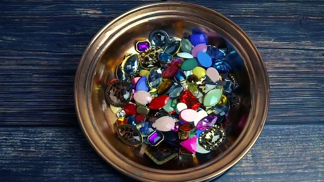 Various colorful diamonds on wooden background