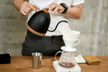 Fototapeta na wymiar Barista making drip coffee in cafe.