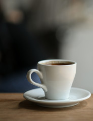 Coffee in white mug on a wooden floor, Close-up shoot vertical image.