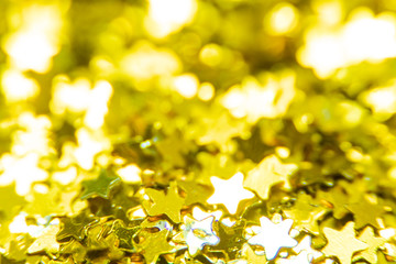 Gold glitter stars texture. Festive sparkling sequins background. Wpaper for Valentine, New Year or Christmas Holidays.