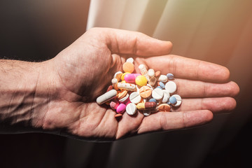 Colorful pills and medicines in the hand