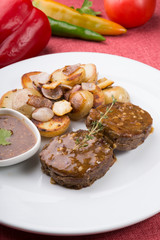 Meat cutlets served with fried potatoes
