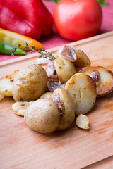 Fried potatoes served on wooden chopping board
