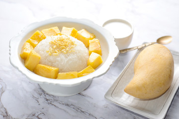 Mango sticky rice is a traditional Thai dessert made with glutinous rice, fresh mango and coconut milk, and eaten with a fork, spoon, or sometimes the hands.
