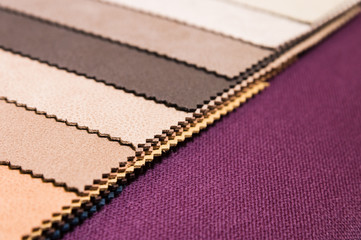 Colorful and bright fabric samples of furniture and clothing upholstery. Close-up of a palette of textile abstract stripes of different colors