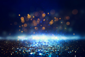 glitter vintage lights background. black, blue, gold and silver. de-focused