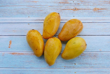 Top view of Chok Anan or Chocanon mango on wooden background.