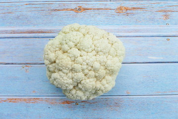 Top view of cauliflower on wooden background.