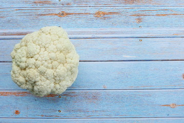 Top view of cauliflower on wooden background. Copy space for text or logo.