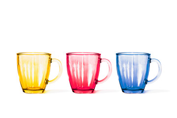glass multicolored mugs on white isolate background