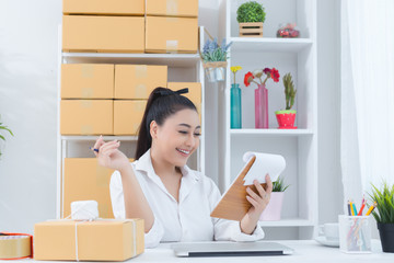 business owner working at home office packaging on background