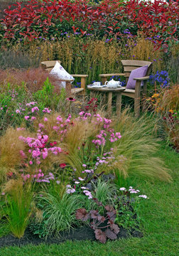 A colourful border in a cottage garden with outdoor eating