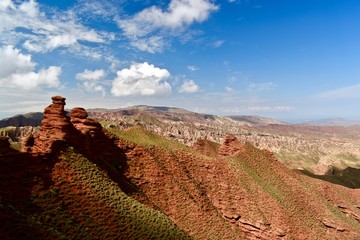 View over sandstone towers with blue sky and clouds in Pingshan Grand Canyon National Park in Gansu province, China