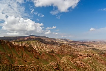 View over sandstone towers with blue sky and clouds in Pingshan Grand Canyon National Park in Gansu province, China
