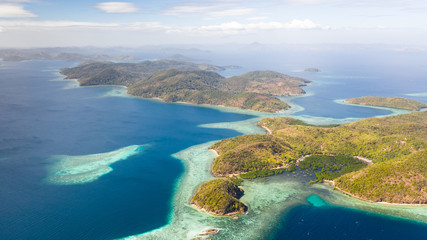 Fototapeta na wymiar aerial seascape Lagoons with blue, azure water in middle of small islands. Palawan, Philippines. tropical islands with blue lagoons, coral reef. Islands of the Malayan archipelago with turquoise