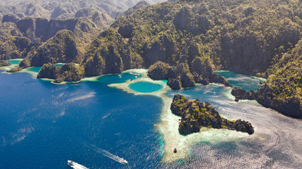 Twin Lagoon in Coron, Palawan, Philippines. Mountain and Sea. Lonely Boat aerial view © Tatiana Nurieva