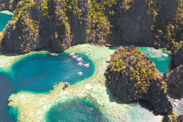 Twin Lagoon in Coron, Palawan, Philippines. Mountain and Sea. Lonely Boat aerial view