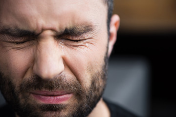 Obraz premium portrait of handsome bearded man crying with closed eyes with tears on face