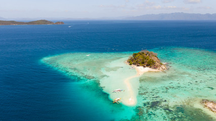 A small island for tourists with a sand bar.Tourists rest on a small island. Philippine Islands aerial view. Philippines, Palawan
