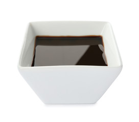 Dish of soy sauce on white background