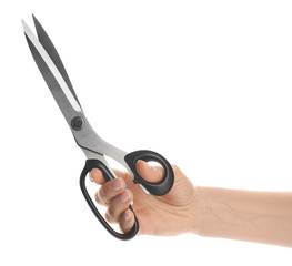 Woman holding sharp sewing scissors on white background, closeup