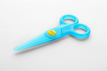 Colorful plastic scissors on white background. School stationery