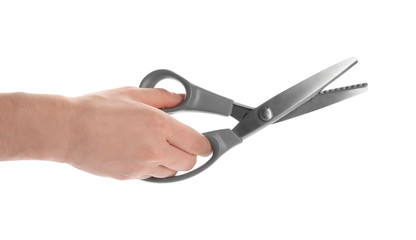 Woman holding sewing scissors on white background, closeup