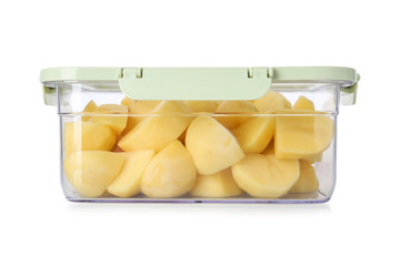 Box with cut fresh raw potatoes on white background