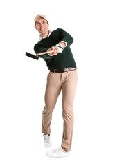 Young man playing golf on white background