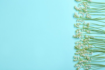 Beautiful lily of the valley flowers and space for text on color background, flat lay