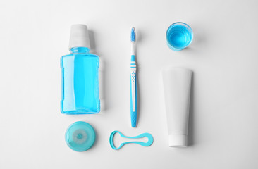 Flat lay composition with toothpaste and oral hygiene products on white background