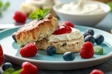 Classic English scones with clotted cream, strawberries jam and other fruit