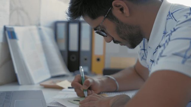 Close-up, Indian Student in Glasses Makes Sketching on Sticker, Prepares for the Medecine Exam