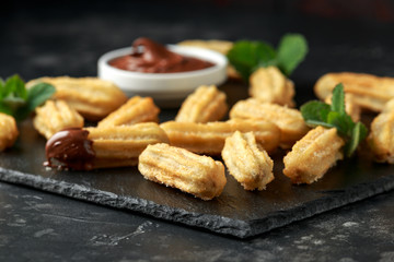 Churros with chocolate dipping sauce. sugar and cinnamon.