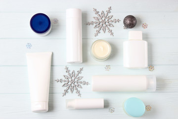 Winter care cosmetics on a colored background top view.