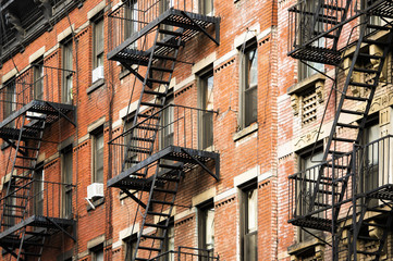 Close-up view of New York City style apartment buildings with emergency stairs along Mott Street in...