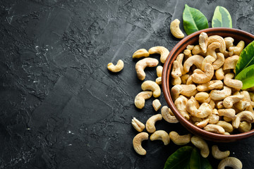 Cashew on a black background. Nuts Top view. Free space for your text.